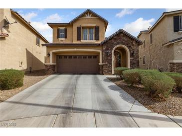 Charming two-story home features a stone-accented entrance, attached garage, and a well-maintained front yard at 6030 Hidden Summit St, North Las Vegas, NV 89031