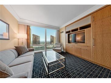 Comfortable living room with a city view and built in cabinets and entertainment center at 2000 N Fashion Show Dr # 3307, Las Vegas, NV 89109