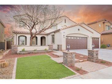Charming two-story stucco home with a well-manicured lawn, mature tree, and a three-car garage at 7466 Matilda St, Las Vegas, NV 89113