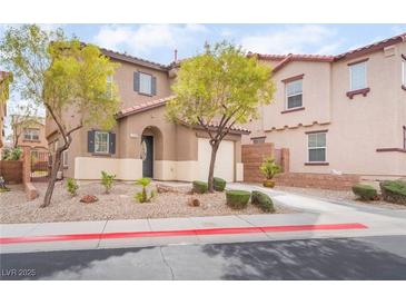 Inviting townhouse showcasing a well-manicured front yard with vibrant greenery and charming curb appeal at 1152 Gecko Rd, Henderson, NV 89002