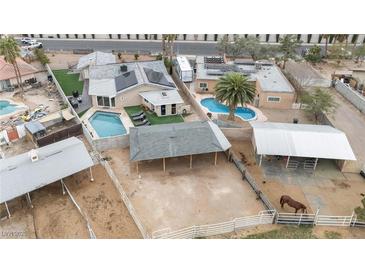 Expansive property with horse facilities, covered stalls, and a refreshing in-ground pool for outdoor enjoyment at 1462 Rawhide St, Las Vegas, NV 89119