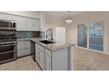 Bright kitchen boasts stainless steel appliances, modern countertops, and a stylish backsplash at 2251 Wigwam Pkwy # 314, Henderson, NV 89074