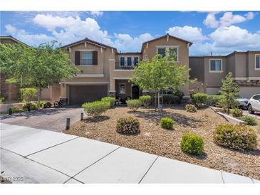 Charming two-story home featuring desert landscaping, a brick driveway, and a cozy balcony at 2833 Athena Hill Ct, Henderson, NV 89052
