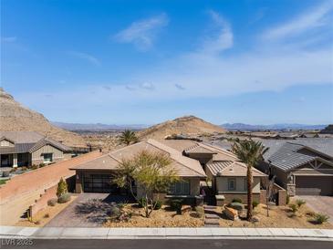 Charming single-story home with desert landscaping, mountain views, and a two-car garage at 3120 Greenscape Ln, Las Vegas, NV 89138