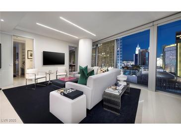 Modern living room featuring floor to ceiling windows with stunning city views and a large sectional sofa at 3726 S Las Vegas Blvd # 1107, Las Vegas, NV 89158
