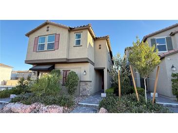 Charming two-story home with a neutral color palette, red shutters, and well-maintained landscaping at 4181 Nopal Serrano Ave, Las Vegas, NV 89141