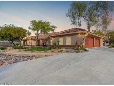 Beautiful home exterior featuring a long driveway, mature landscaping, and a red tile roof at 5340 N Campbell Rd, Las Vegas, NV 89149