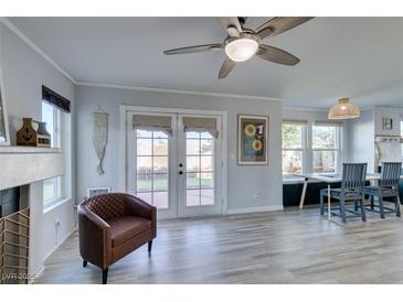 Cozy living room with luxury vinyl flooring, fireplace and view to backyard at 182 Cantamar St, Henderson, NV 89074