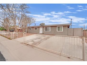 Charming single-story home with fenced yard and covered driveway, providing both privacy and curb appeal at 3305 Palomar St, North Las Vegas, NV 89030