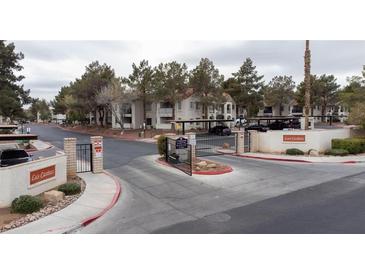 View of the gated entrance to the Las Casitas community with mature trees at 4866 Nara Vista Way # 202, Las Vegas, NV 89103