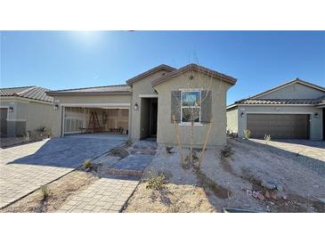 Charming single-story home showcasing desert landscaping and an attached two-car garage at 9067 Mapledale Ranch Ct, Las Vegas, NV 89139