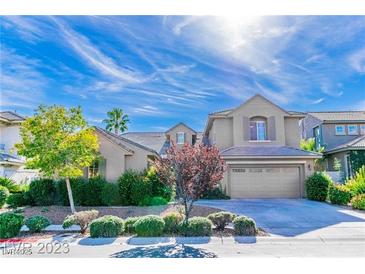 Charming two-story home with landscaped front yard, driveway, and a neutral color palette, perfect for curb appeal at 10227 Sunset Gardens Dr, Las Vegas, NV 89135