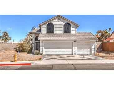Charming two-story home with a three-car garage and well-maintained landscaping at 1209 Shifting Sands Dr, Las Vegas, NV 89108