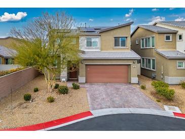 Beautiful two-story home featuring a brick driveway, desert landscaping, and a modern architectural design at 340 Largo Vista Ct, North Las Vegas, NV 89084
