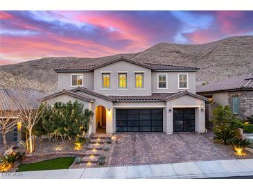 Elegant two-story home with a three-car garage, landscaped front yard, and mountain views at 3929 Reyes Ave, Las Vegas, NV 89141
