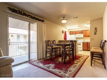 Cozy living room with dining area and a sliding glass door to the balcony at 4411 Alexis Dr # 444, Las Vegas, NV 89103