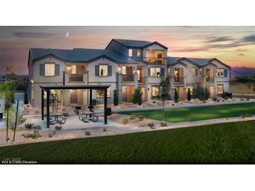 Charming townhome showcasing a picnic area, a well-maintained lawn, and exterior architectural details at 470 Ylang Pl # Lot 9, Henderson, NV 89015