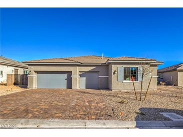 Charming single-story home with a three-car garage and beautiful brick driveway at 5846 Slate Rock Ct, Las Vegas, NV 89149