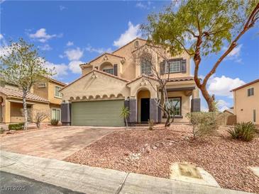 Charming two-story stucco home featuring a well-maintained yard, two-car garage, and inviting curb appeal at 7110 Brighton Village St, Las Vegas, NV 89166