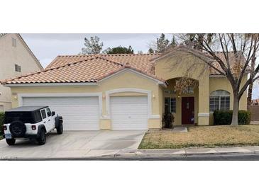 Charming single-story home featuring a two-car garage and a well-maintained front yard with mature tree at 7456 Oatman Ln, Las Vegas, NV 89120