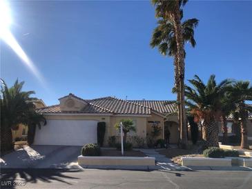 Charming single-story home with desert landscaping, palm trees, and a two-car garage at 7613 Falconwing Ave, Las Vegas, NV 89131