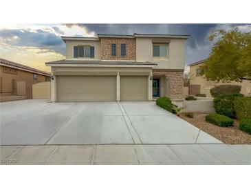 Charming two-story home showcasing a well-manicured lawn, stone accents, and a spacious three-car garage at 780 Flowing Meadow Dr, Henderson, NV 89014