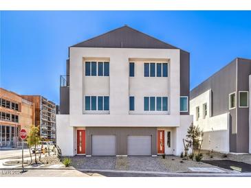 Modern two-story home boasting clean lines, dual garage doors, and eye-catching red front doors at 8629 Ensworth St # 113, Las Vegas, NV 89123