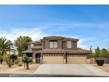 Charming two-story home featuring a three-car garage, desert landscaping, and a timeless architectural design at 9108 Ghost Mountain Ave, Las Vegas, NV 89129