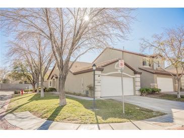 Inviting home featuring desert landscaping, a large two-car garage and a tile roof at 10229 Birch Bluff Ln, Las Vegas, NV 89145