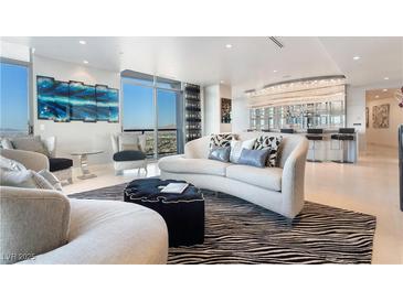 Bright living room featuring elegant furnishings, city views, and statement chandelier at 200 W Sahara Ave # 4101, Las Vegas, NV 89102