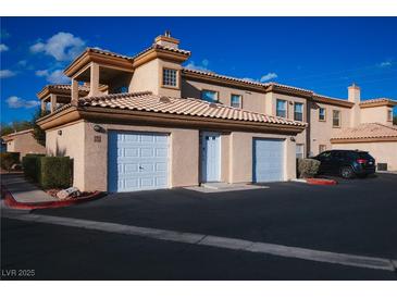Charming townhome with two-car garage and well-maintained landscaping at 6700 Amarinta Ave # 104, Las Vegas, NV 89108