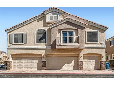 Inviting townhome featuring a private balcony and three-car garage, perfect for comfortable living at 1142 Heavenly Harvest Pl # 2, Henderson, NV 89002