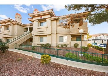 Multi-level condo building featuring tan stucco, terracotta roof tiles, and well-maintained landscaping at 354 Sunward Dr # 0, Henderson, NV 89014