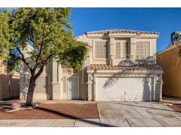 Charming two-story home boasts a well-maintained front yard and classic architectural details under a clear blue sky at 7228 Buglehorn St, Las Vegas, NV 89131
