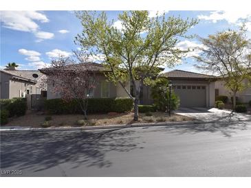 Charming single-story home featuring a well-manicured yard and a spacious two-car garage with appealing curb appeal at 10479 Garden Light Dr, Las Vegas, NV 89135