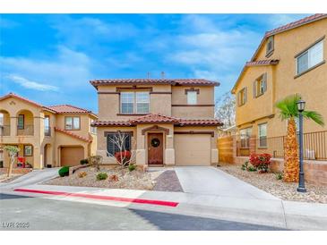 Charming two-story home featuring a red tile roof and desert-friendly landscaping for curb appeal at 1140 Paradise Vista Dr, Henderson, NV 89002