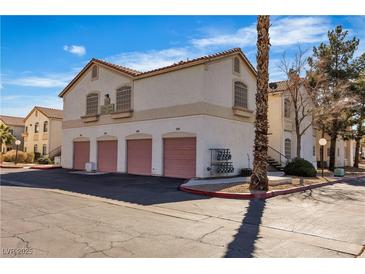 Charming multi-Gathering residence featuring three garage doors and desert landscaping under a clear, blue sky at 1405 S Nellis Blvd # 2087, Las Vegas, NV 89104