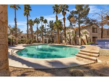 Community pool surrounded by palm trees and lush landscaping offers a refreshing escape at 1405 S Nellis Blvd # 2087, Las Vegas, NV 89104