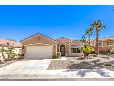 Charming single-story home with a well-manicured front yard and a two-car garage at 1821 Eagle Mesa Ave, Henderson, NV 89012
