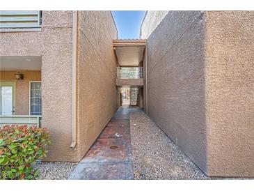 Exterior walkway shows access to units and building design at 2110 Sealion Dr # 101, Las Vegas, NV 89128