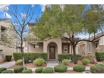 Charming home featuring a well-maintained front yard with lush green landscaping and mature trees at 2231 Desert Prairie St, Las Vegas, NV 89135