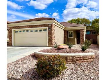 Charming single-story home with brick accents, landscaped yard, and two-car garage at 2575 Evening Twilight Ave, Henderson, NV 89044