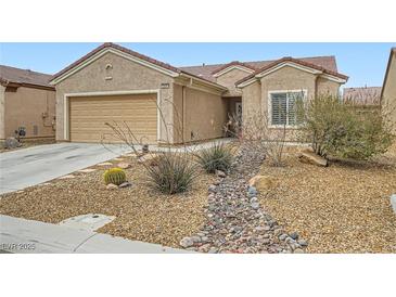 Charming single-story home with desert landscaping, rock accents, and a two-car garage at 3220 Flinthead Dr, North Las Vegas, NV 89084