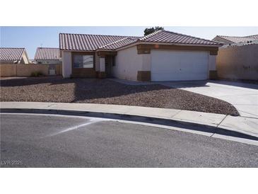 Charming single-story home featuring a tiled roof and a two-car garage, complemented by desert landscaping at 3745 Saint Peter Ct, North Las Vegas, NV 89031