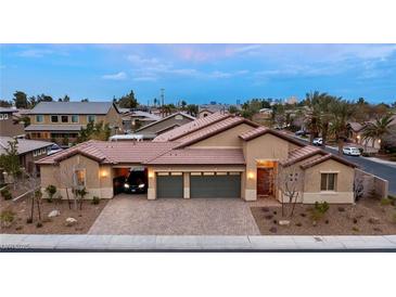 Beautiful single-story home boasts three-car garage and desert landscaping at 3870 Valles Caldera Ct, Las Vegas, NV 89118