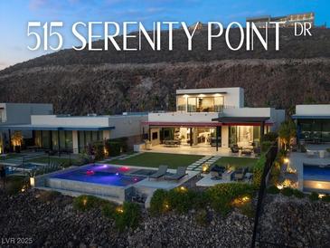 Stunning modern home with a pool, lush landscaping, and a hillside backdrop at 515 Serenity Point Dr, Henderson, NV 89012