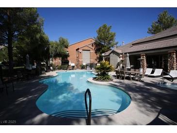 Enjoy the community's refreshing pool, surrounded by mature trees and comfortable seating areas at 555 E Silverado Ranch Blvd # 1171, Las Vegas, NV 89183