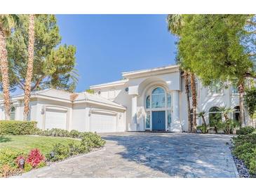 Elegant two-story home featuring a blue double-door entry, white exterior, and a three-car garage at 2339 Prometheus Ct, Henderson, NV 89074