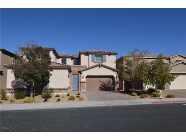 Charming two-story home features desert landscaping, brick driveway, and an attached two-car garage at 2822 Poseidon Shore Ave, Henderson, NV 89052