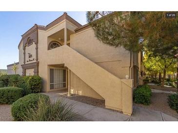Charming condo with well-manicured landscaping, covered entryway, and private staircase to upper units at 3673 Ian Thomas St # 201, Las Vegas, NV 89129